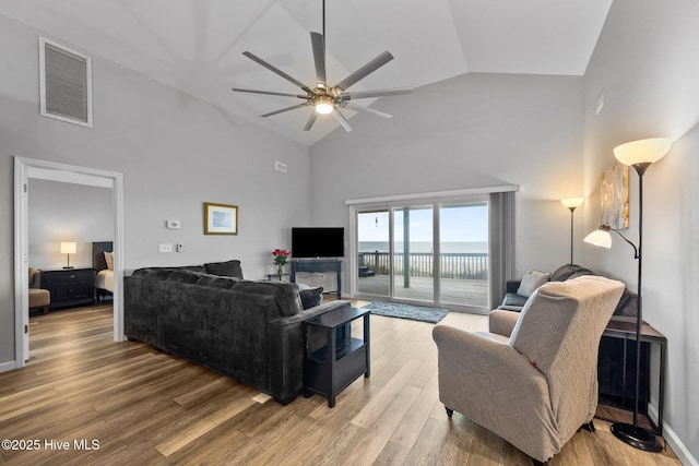 232 Seashore Dr, North Topsail Beach, NC 28460 - living room with high vaulted ceiling, a ceiling fan, and light wood-style flooring