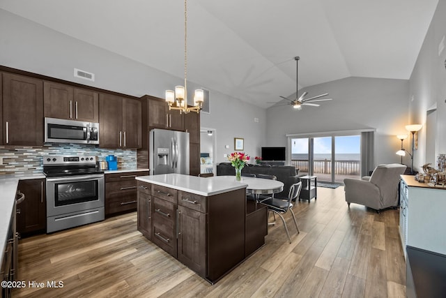 232 Seashore Dr, North Topsail Beach, NC 28460 - kitchen with appliances with stainless steel finishes, open floor plan, a chandelier, a ceiling fan, and light countertops