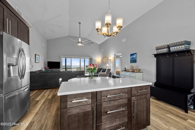 232 Seashore Dr, North Topsail Beach, NC 28460 - kitchen with stainless steel fridge, a ceiling fan, high vaulted ceiling, a chandelier, and dark brown cabinets