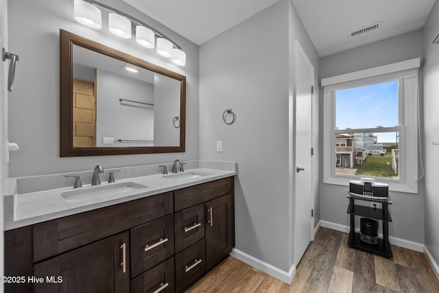 232 Seashore Dr, North Topsail Beach, NC 28460 - full bath with double vanity, wood finished floors, and baseboards