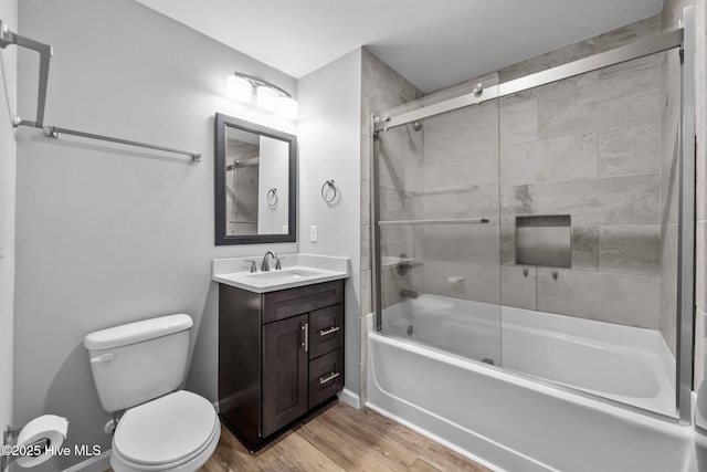 232 Seashore Dr, North Topsail Beach, NC 28460 - full bath with shower / bath combination with glass door, wood finished floors, vanity, and toilet