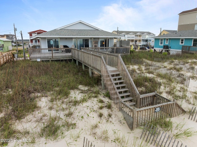 232 Seashore Dr, North Topsail Beach, NC 28460 - back of property with roof with shingles, a deck, and stairs