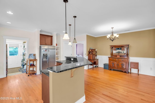 2013 Adams St, Wilmington, NC 28401 - kitchen with stainless steel fridge with ice dispenser, a kitchen breakfast bar, a chandelier, a center island, and light wood-type flooring