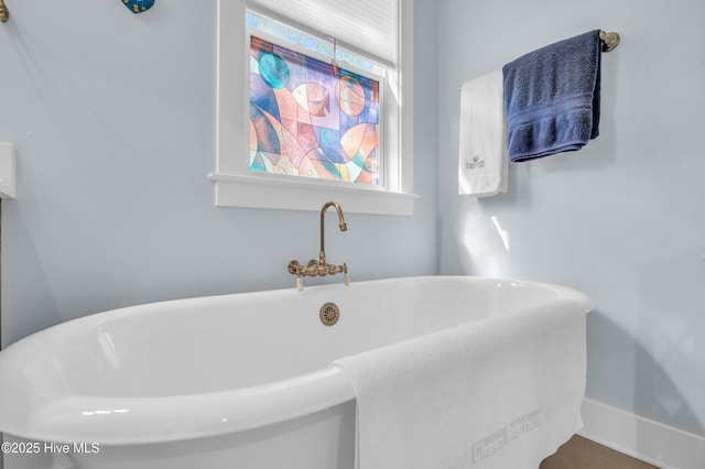 2013 Adams St, Wilmington, NC 28401 - bathroom featuring a freestanding tub and baseboards