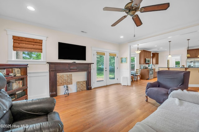 2013 Adams St, Wilmington, NC 28401 - living area with ceiling fan, light wood-type flooring, a wainscoted wall, recessed lighting, and a decorative wall