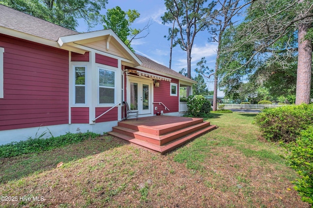 2013 Adams St, Wilmington, NC 28401 - back of house featuring french doors, a lawn, a wooden deck, and a shingled roof