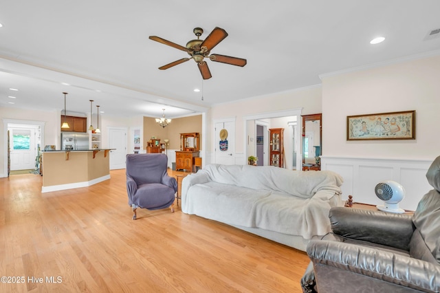 2013 Adams St, Wilmington, NC 28401 - living area with light wood-style flooring, ceiling fan, a chandelier, crown molding, and recessed lighting