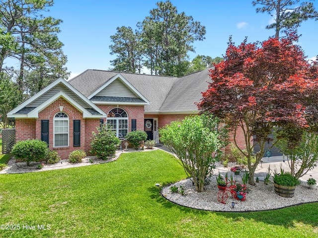 4 Golf Crest Ct, Carolina Shores, NC 28467 - view of front of home featuring brick siding, a front lawn, and a shingled roof
