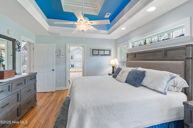 4 Golf Crest Ct, Carolina Shores, NC 28467 - bedroom with light wood-style flooring, a tray ceiling, recessed lighting, a ceiling fan, and baseboards