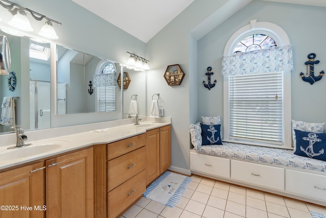 4 Golf Crest Ct, Carolina Shores, NC 28467 - bathroom with lofted ceiling, plenty of natural light, double vanity, tile patterned flooring, and an enclosed shower