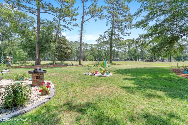 4 Golf Crest Ct, Carolina Shores, NC 28467 - view of grassy yard featuring view of scattered trees