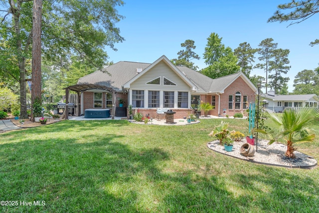 4 Golf Crest Ct, Carolina Shores, NC 28467 - rear view of house with a hot tub, brick siding, and a yard