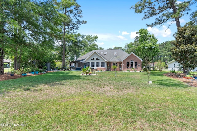 4 Golf Crest Ct, Carolina Shores, NC 28467 - back of house featuring a lawn and brick siding