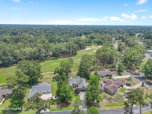4 Golf Crest Ct, Carolina Shores, NC 28467 - aerial perspective of suburban area featuring a heavily wooded area