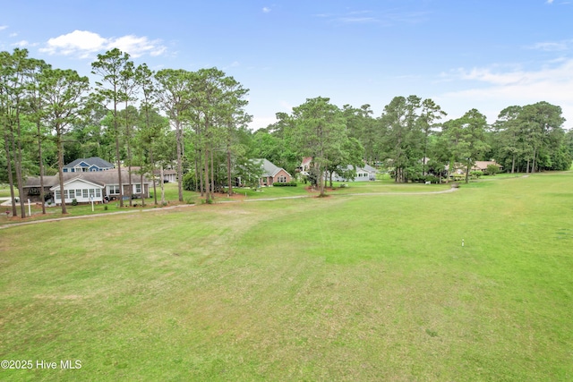 4 Golf Crest Ct, Carolina Shores, NC 28467 - view of green lawn with view of wooded area
