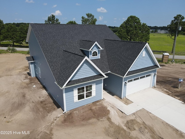 309 River Oats Ct, Holly Ridge, NC 28445 - traditional home featuring driveway, a shingled roof, and an attached garage