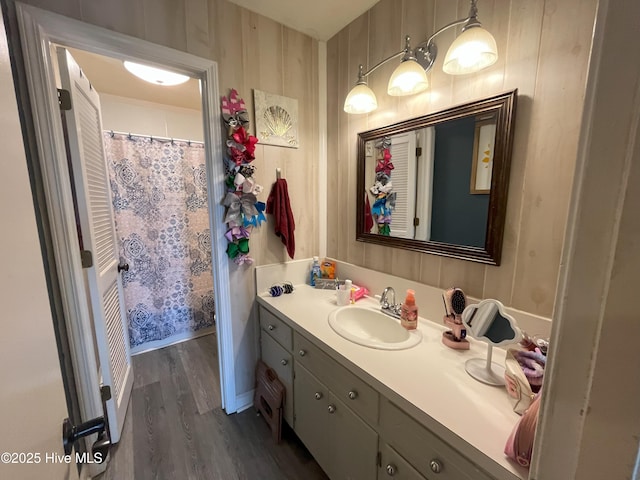 1076 Corbett Town Rd, Snow Hill, NC 28580 - bathroom with wood finished floors, vanity, and wallpapered walls