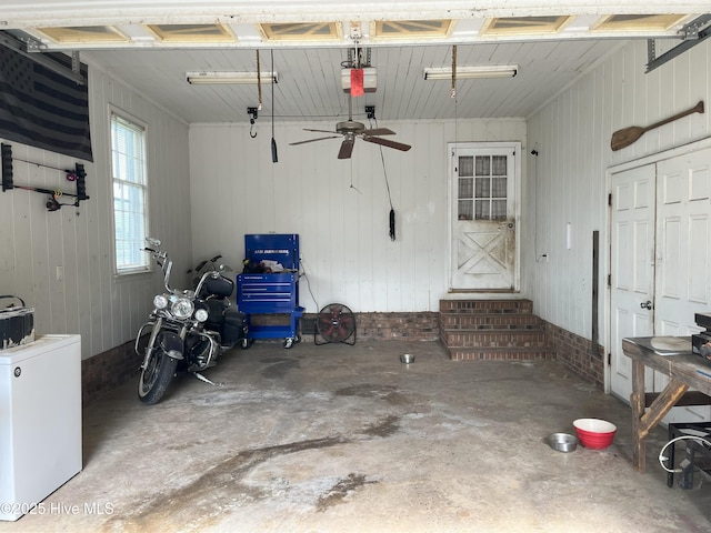 1076 Corbett Town Rd, Snow Hill, NC 28580 - garage with a garage door opener, a ceiling fan, and fridge