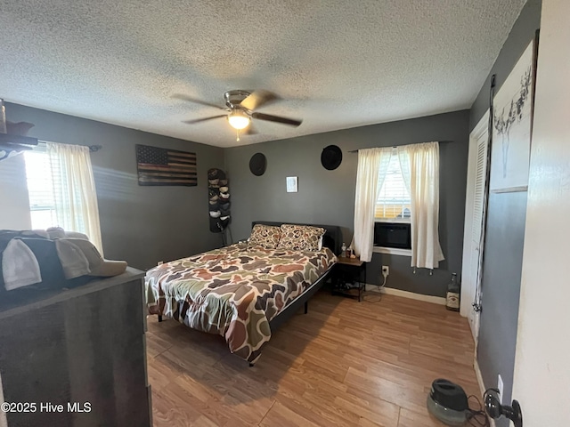 1076 Corbett Town Rd, Snow Hill, NC 28580 - bedroom featuring wood finished floors, a textured ceiling, ceiling fan, baseboards, and a closet