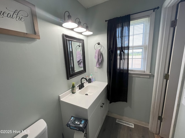 1076 Corbett Town Rd, Snow Hill, NC 28580 - bathroom featuring toilet, wood finished floors, vanity, and baseboards