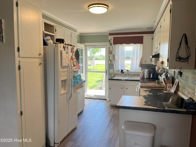 1076 Corbett Town Rd, Snow Hill, NC 28580 - kitchen with white refrigerator with ice dispenser, open shelves, dark countertops, a sink, and white cabinets