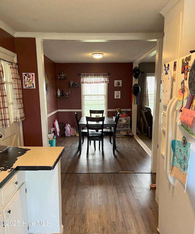 1076 Corbett Town Rd, Snow Hill, NC 28580 - dining area featuring healthy amount of natural light, dark wood-style floors, and ornamental molding