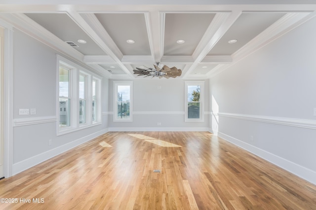 110 Dow Rd N, Carolina Beach, NC 28428 - spare room featuring plenty of natural light, beam ceiling, crown molding, light wood-style flooring, and coffered ceiling