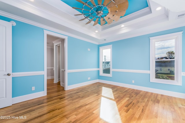 110 Dow Rd N, Carolina Beach, NC 28428 - spare room with a tray ceiling, crown molding, wood finished floors, baseboards, and recessed lighting
