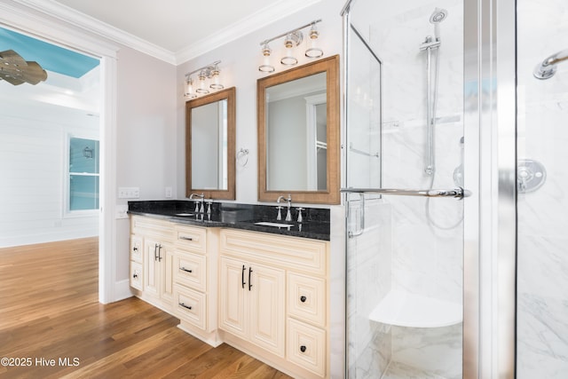 110 Dow Rd N, Carolina Beach, NC 28428 - bathroom featuring a marble finish shower, double vanity, ornamental molding, wood finished floors, and baseboards