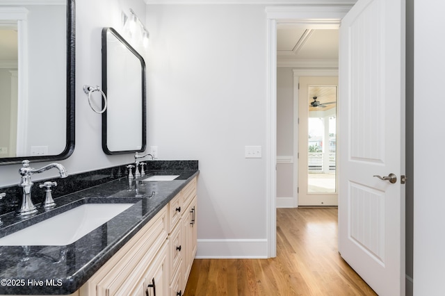 110 Dow Rd N, Carolina Beach, NC 28428 - bathroom with wood finished floors, crown molding, double vanity, and baseboards
