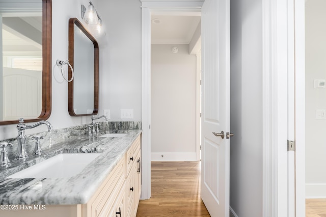 110 Dow Rd N, Carolina Beach, NC 28428 - bathroom with double vanity, wood finished floors, baseboards, and ornamental molding