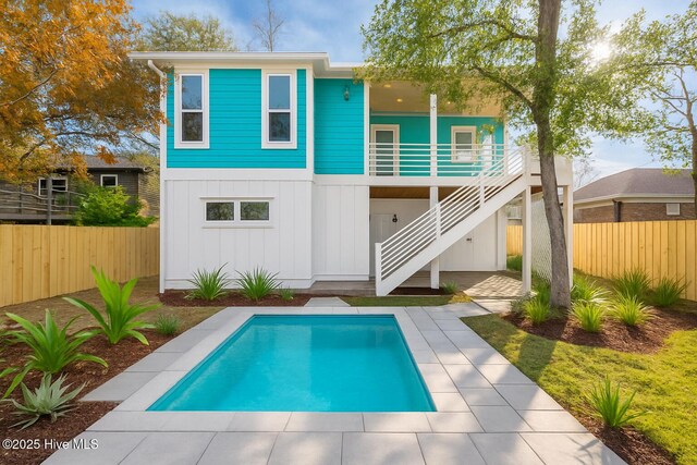 110 Dow Rd N, Carolina Beach, NC 28428 - back of house featuring stairway, board and batten siding, and a patio area