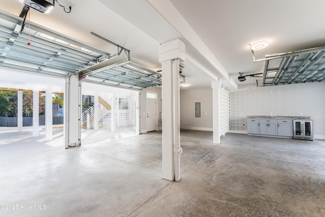 110 Dow Rd N, Carolina Beach, NC 28428 - garage with wine cooler, electric panel, a garage door opener, and french doors