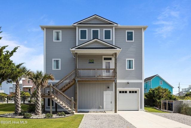 1905 Emerald Dr, Emerald Isle, NC 28594 - coastal inspired home with an attached garage, stairway, concrete driveway, and a porch