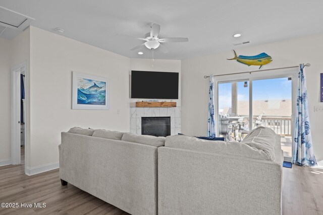 1905 Emerald Dr, Emerald Isle, NC 28594 - living area featuring wood finished floors, a ceiling fan, baseboards, a tile fireplace, and recessed lighting