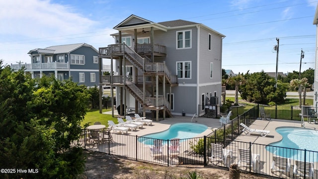 1905 Emerald Dr, Emerald Isle, NC 28594 - rear view of house with stairs, a community pool, a patio area, and ceiling fan