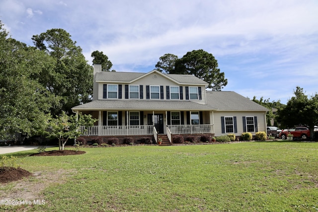 1212 Williamsburg Ct, Wilmington, NC 28411 - view of front of house with a chimney, covered porch, and a front yard