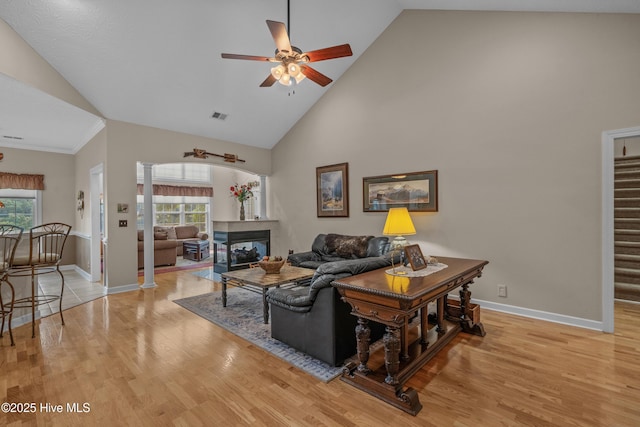 550 Sunset Lakes Blvd SW, Sunset Beach, NC 28468 - living area with ceiling fan, light wood finished floors, high vaulted ceiling, baseboards, and ornate columns