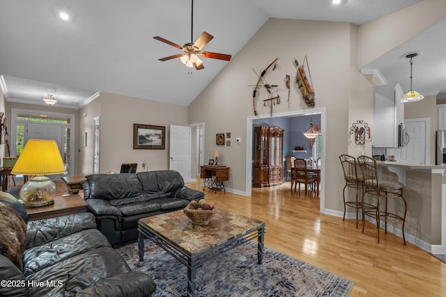 550 Sunset Lakes Blvd SW, Sunset Beach, NC 28468 - living room featuring ceiling fan, light wood-type flooring, high vaulted ceiling, and baseboards
