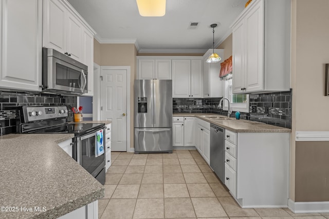 550 Sunset Lakes Blvd SW, Sunset Beach, NC 28468 - kitchen featuring appliances with stainless steel finishes, a sink, white cabinetry, and ornamental molding