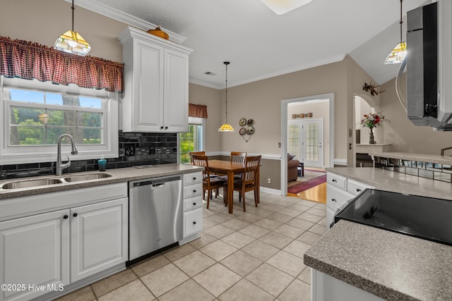 550 Sunset Lakes Blvd SW, Sunset Beach, NC 28468 - kitchen with stainless steel appliances, a sink, light tile patterned floors, white cabinets, and decorative backsplash