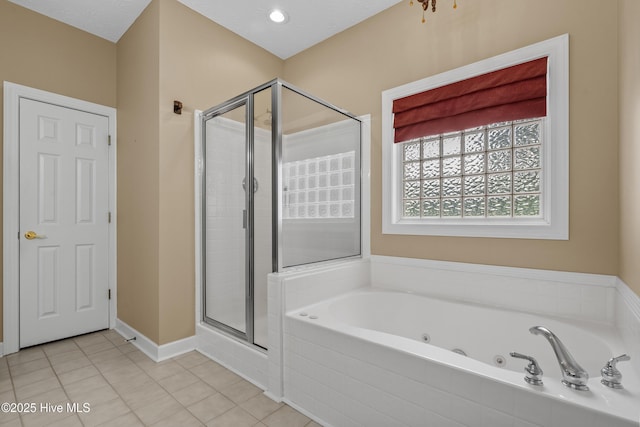 550 Sunset Lakes Blvd SW, Sunset Beach, NC 28468 - full bathroom with a stall shower, a whirlpool tub, tile patterned flooring, and baseboards