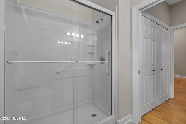 550 Sunset Lakes Blvd SW, Sunset Beach, NC 28468 - full bathroom with a shower stall, wood finished floors, and baseboards