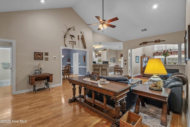 550 Sunset Lakes Blvd SW, Sunset Beach, NC 28468 - living room with ceiling fan, high vaulted ceiling, light wood finished floors, a fireplace, and recessed lighting
