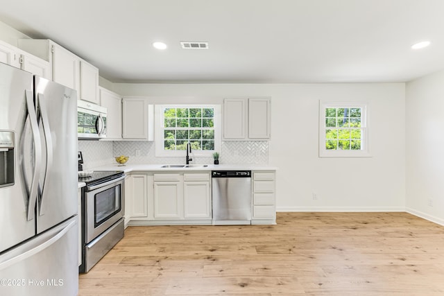 150 Willetts Dr, Southport, NC 28461 - kitchen featuring stainless steel appliances, a sink, plenty of natural light, tasteful backsplash, and recessed lighting