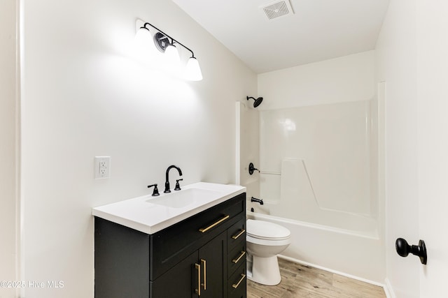 150 Willetts Dr, Southport, NC 28461 - bathroom with toilet, vanity, wood finished floors, and shower / tub combination