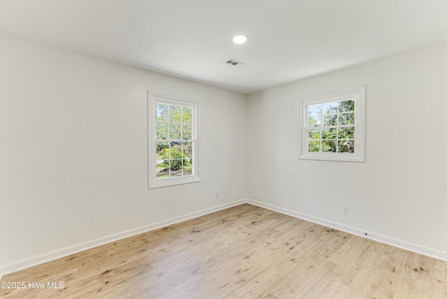 150 Willetts Dr, Southport, NC 28461 - spare room featuring light wood finished floors, plenty of natural light, baseboards, and recessed lighting