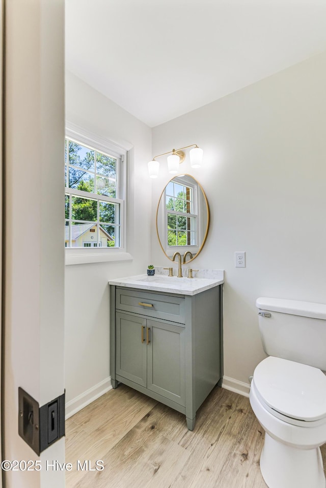 150 Willetts Dr, Southport, NC 28461 - bathroom with wood finished floors, plenty of natural light, vanity, and baseboards