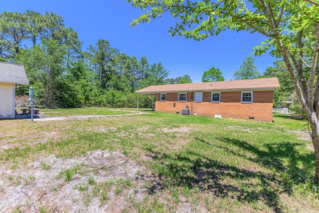 150 Willetts Dr, Southport, NC 28461 - rear view of house with brick siding, a lawn, and crawl space