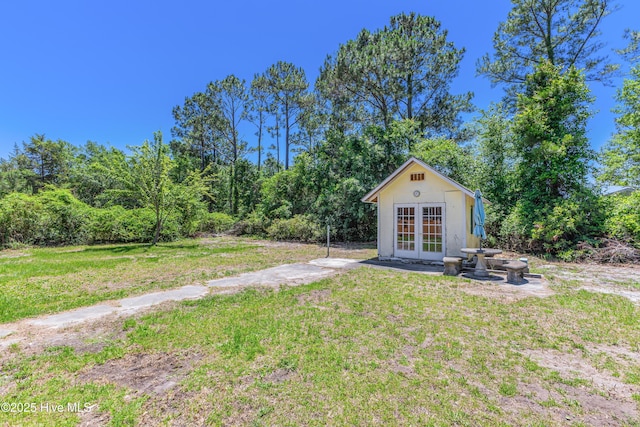 150 Willetts Dr, Southport, NC 28461 - view of grassy yard featuring french doors and an outdoor structure